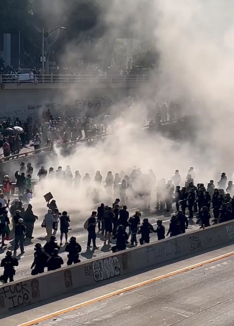 California Highway Patrol officers in riot gear made their way onto the 101 Freeway in downtown Los Angeles, backing up Los Angeles police officers as they tried to contain crowds of people who spilled onto the major thoroughfare.